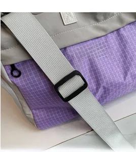 Detail of adjustable strap and purple mesh ripstop fabric on large travel tote