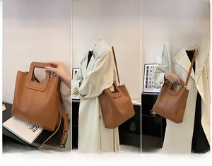 Detail of caramel PU leather bucket bag showing hollow square handle and shoulder strap