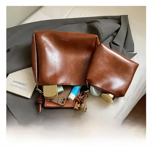 Detail view of the spacious interior of a brown tote bag with a matching small pouch