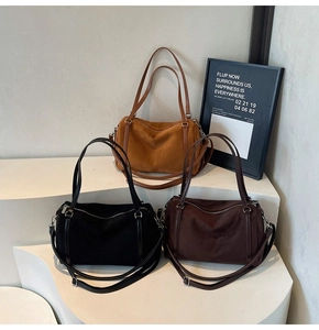 Three suede Boston bags in brown, black, and dark coffee with silver zippers