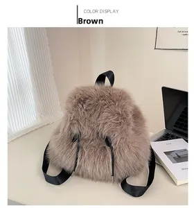 Detailed close-up of brown plush faux fur backpack with black straps and drawstring detail