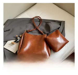 Close-up of brown vintage bucket bag with matching inner pouch and logo detail