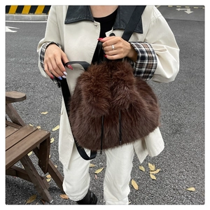 Detailed close-up of dark brown plush backpack with soft faux fur and black straps