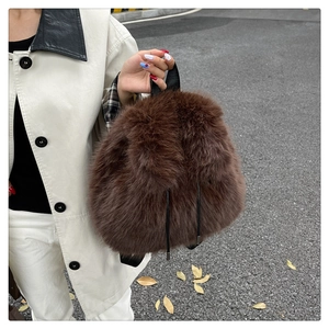 Brown faux fur backpack featuring high-density plush texture and chic black drawstrings