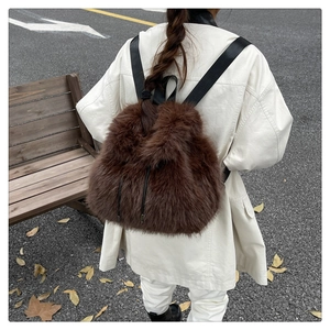 Detail of soft brown faux fur backpack with black drawstring and nylon straps
