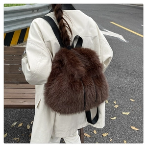 Detail of plush brown faux fur backpack with soft texture and black textile straps