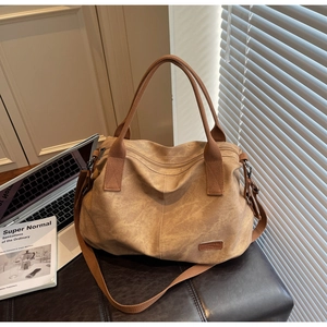 Large capacity canvas tote bag with laptop and books in a sunlit lifestyle setting