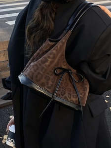 Fashionable leopard print shoulder bucket bag with black bow detail and leather trim