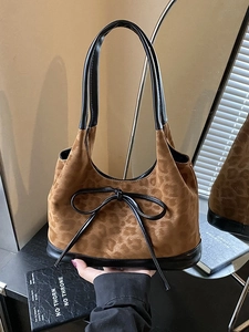 Fashionable leopard print shoulder bag with black leather trim and bow knot detail