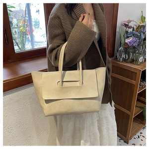 Creamy white leather tote bag shown in a lifestyle setting with an elegant soft design