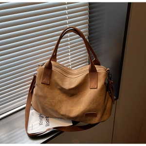 Macro shot of brown caramel tote bag with vintage brushed texture and adjustable strap