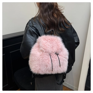 Pink faux fur backpack with black adjustable nylon straps shown on model back view