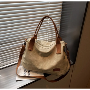 Canvas tote bag with adjustable strap shown under sunlight with shutter shadows