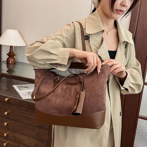 Detail of vintage suede leopard print tote bag with brown leather trim and mini pouch