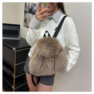 Detailed view of brown plush backpack featuring fluffy faux fur texture and black straps