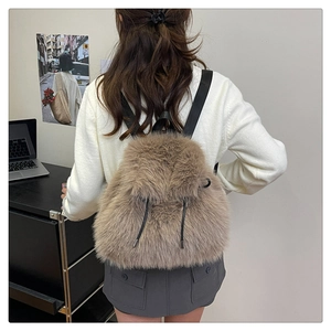 Furry plush backpack in light brown showing the soft texture and black nylon straps