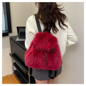 Macro detail of plush burgundy backpack with drawstring closure and soft texture
