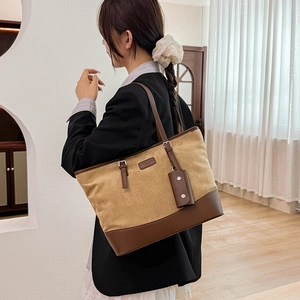 Detail of large tote bag in khaki suede and brown leather patchwork with small pouch