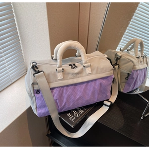 Detail view of large capacity travel bag with thick handles and adjustable strap