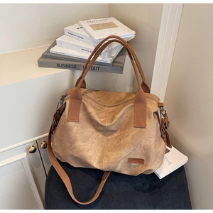Close-up of vintage brown tote bag showing textured material and adjustable strap