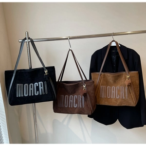 Detailed display of vintage MOACAI tote bags in black, dark brown, and caramel brown colors