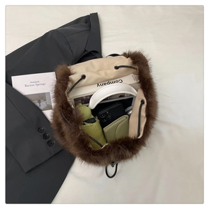 Deep brown faux fur bucket bag showing spacious interior with books and daily essentials