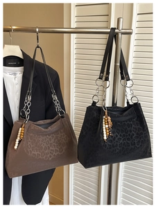 Leopard print tote bags with metal chain straps and bead charms in brown and black
