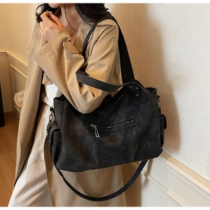 Detail view of large matte dark grey tote bag with back zipper and wide handle