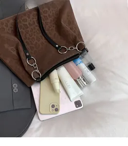 Detail view of large leopard print tote bag showing spacious interior with daily essentials