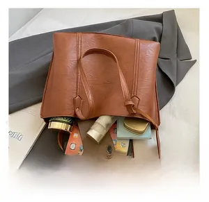 Interior view of large brown vintage tote bag showing ample space for phone and notebook