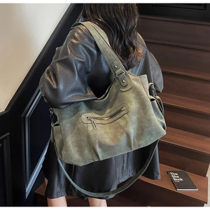 Detail of vintage olive green matte tote bag with front zipper and metal hardware