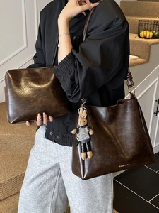 Minimalist coffee brown faux leather tote bag with a small rabbit charm and matching clutch