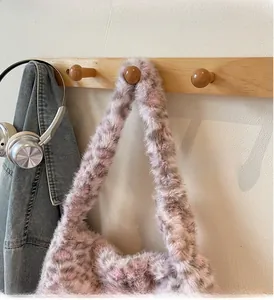 Detail of soft leopard print faux fur tote bag with pink and gray plush texture
