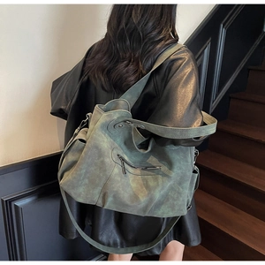 Close-up of vintage grey-green oversized tote bag with matte texture and metal zipper detail