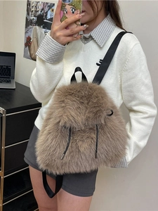Brown fluffy plush backpack with drawstring closure and black nylon straps for winter