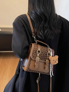 Retro brown leather women's backpack with leopard print flaps and bear charm