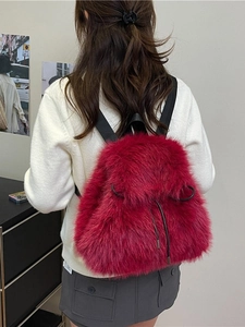 Fuzzy red faux fur backpack with black drawstring closure for winter fashion styles