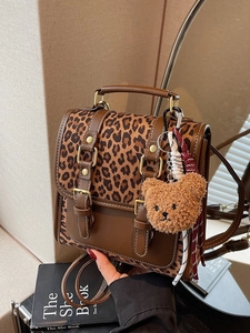 Vintage leopard print backpack with brown leather patchwork and a cute bear charm