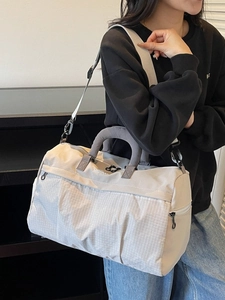 Large beige waterproof travel bag with mesh texture and adjustable shoulder strap