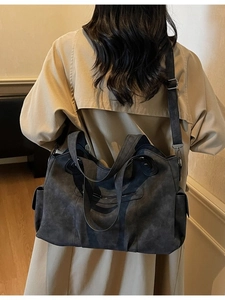 Retro charcoal grey large capacity tote bag worn with a khaki coat for commuting