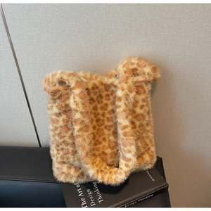 Close-up of fluffy leopard print plush tote bag on a minimalist display surface