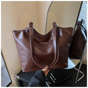 Close-up of vintage large capacity dark brown tote bag with leather texture and white lettering