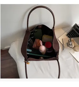 Spacious interior of dark brown suede tote bag showing large storage capacity