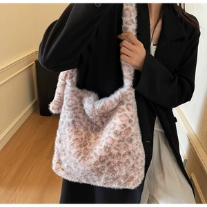 Close-up of pink leopard print plush tote bag with soft faux fur texture on shoulder