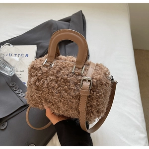 Close-up of warm brown faux shearling and leather textures on a stylish bucket bag
