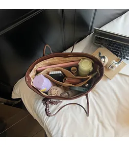 Interior view of brown faux leather tote bag showing spacious compartments and daily essentials