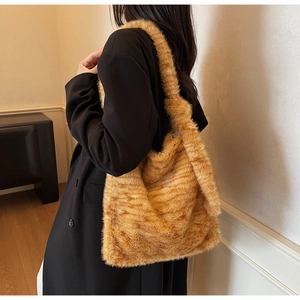Close-up of plush tiger print shoulder bag showcasing soft faux fur texture and large capacity