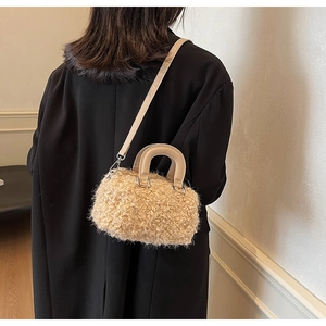 Detail of plush faux shearling texture on stylish beige cylinder crossbody bag for women