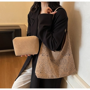 Detailed close-up showing the intricate laser-cut floral pattern on the sand yellow tote bag