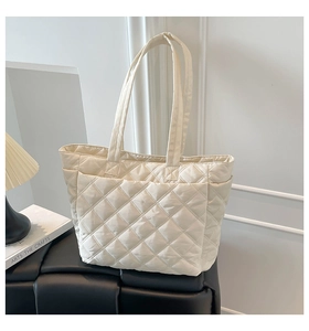 Detail shot of the quilted diamond pattern and high-quality nylon fabric on the tote bag